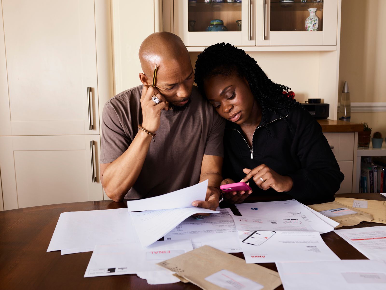 Homeowners reviewing renovation budget documents at a table